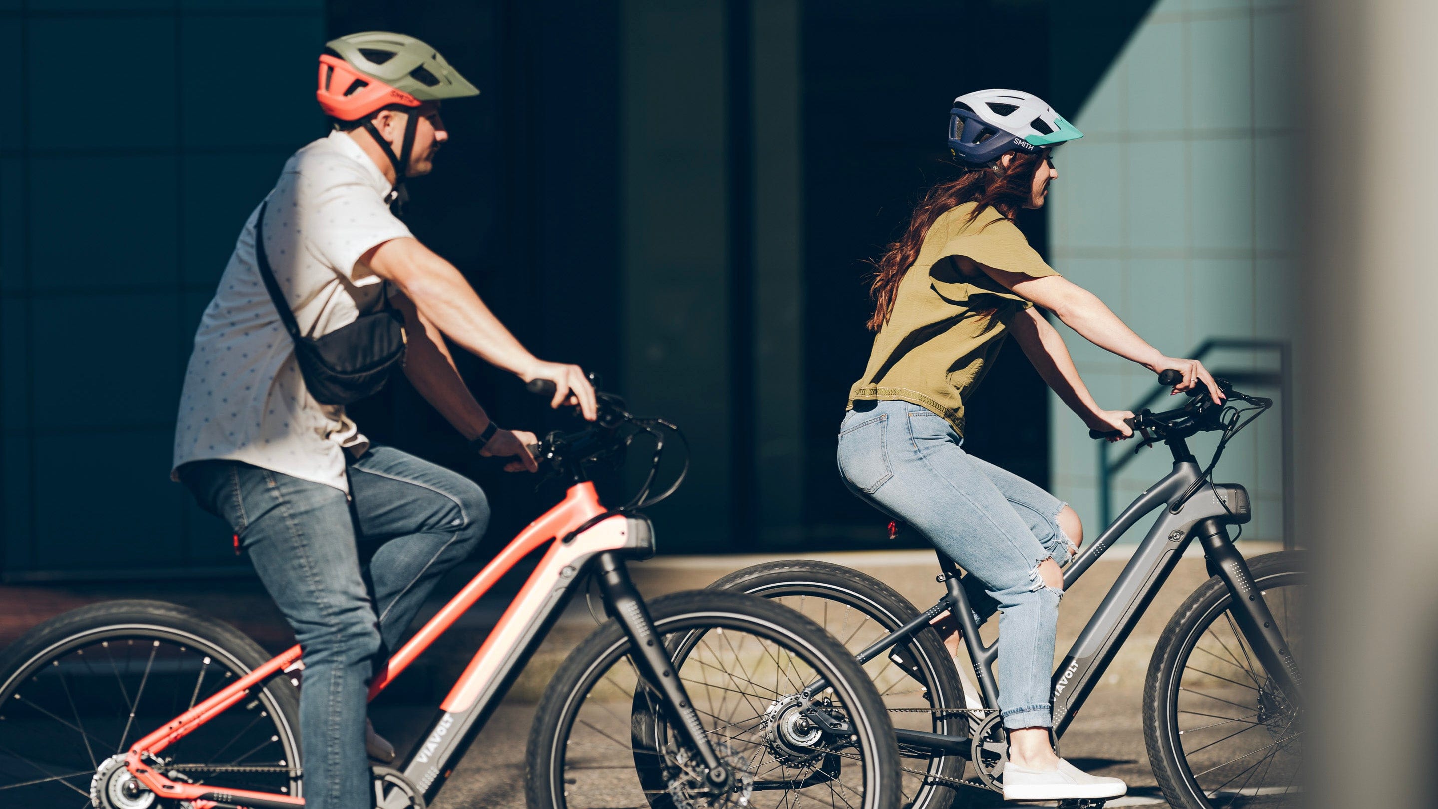 A side profile shot of two riders on the Vvolt Alpha II ebike